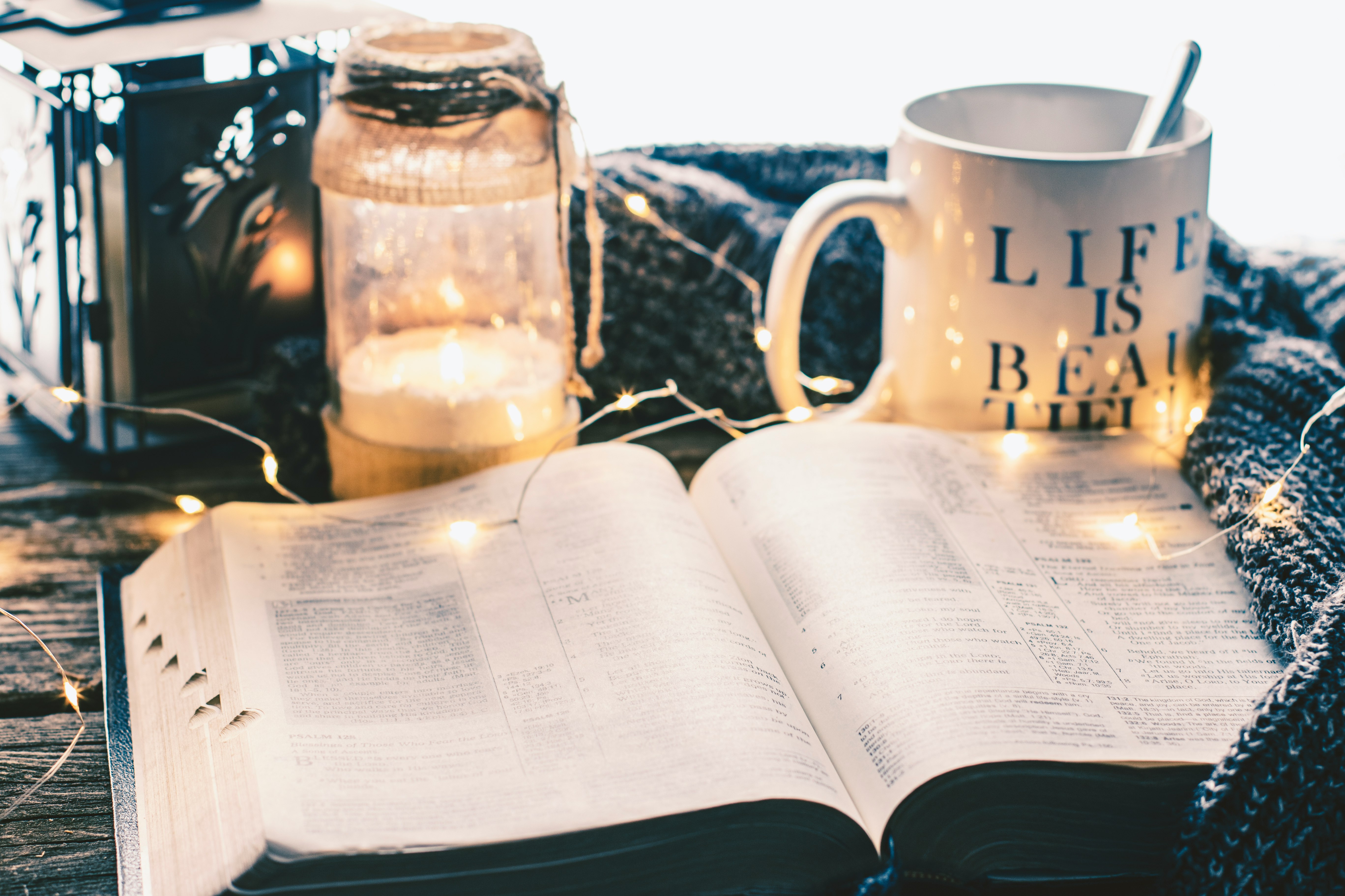 white ceramic mug beside clear glass jar